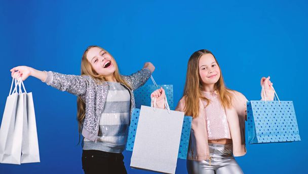 Happy children in shop with bags. Shopping is best therapy. Shopping day happiness. Sisters shopping together. Buy clothes. Fashionista addicted buyer. Fashion boutique kids. Shopping of her dreams - Fotoğraf, Görsel