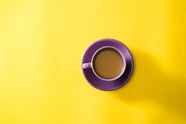 Purple cup of coffee on the yellow background - Photo, Image