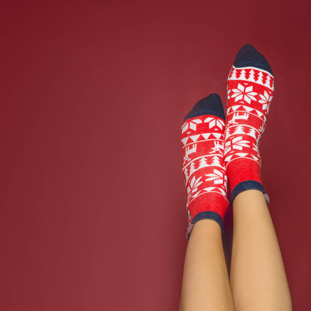 woman legs in color red socks isolated, legs in Christmas socks - Foto, imagen