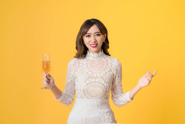 Young beautiful sexy woman in white fashion dress drinking alcohol cocktail - 写真・画像