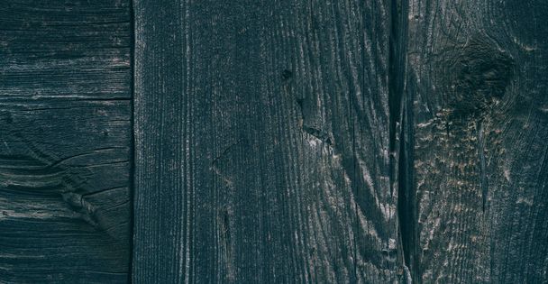 The wall of old wooden house in traditional swiss alpine village. Rural mountain chalet. Dark wood texture background surface with old natural pattern - Фото, зображення