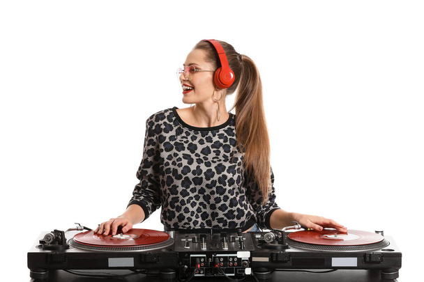 Female dj playing music on white background - Фото, изображение