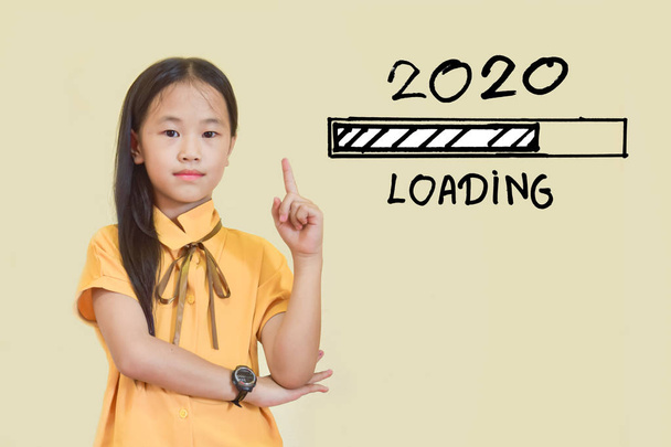 New year concept. girl pointing at 2020 loading process on light yellow background. - 写真・画像