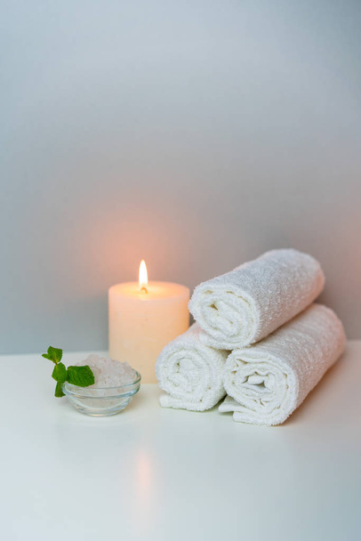 SPA procedures concept photo with candle light, sea salt and stack of towels. - Φωτογραφία, εικόνα