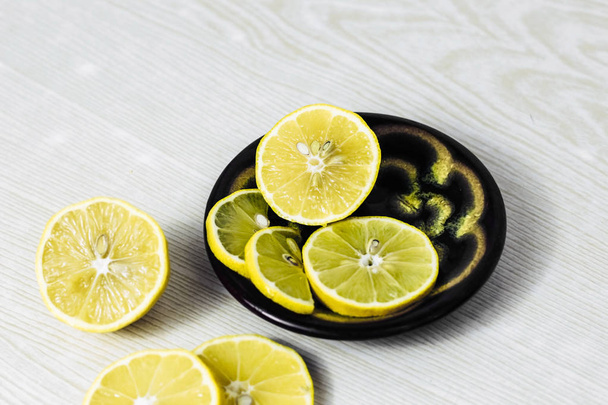 lemon slices neatly cut and lie on a wooden background. space for text - Foto, immagini