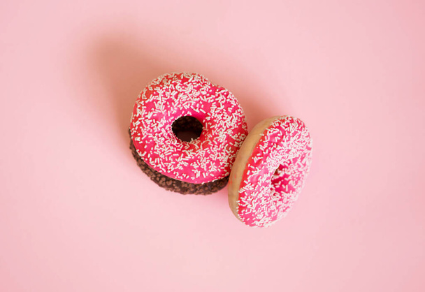Donuts saborosos e deliciosos com diferentes glacê e enchimento em um fundo colorido
. - Foto, Imagem