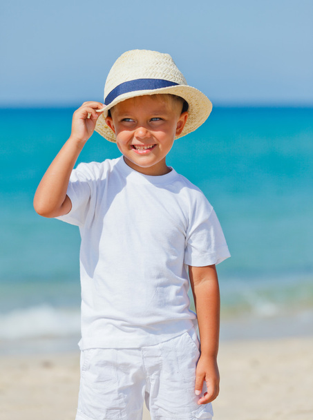 Boy with hat on the beach - Photo, image