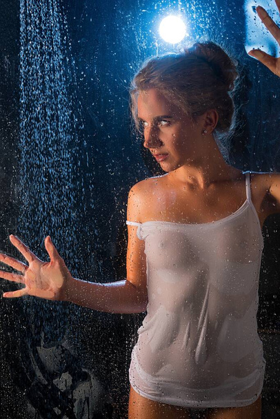 Blonde in wet t-shirt in shower shot in the dark - Foto, Imagem