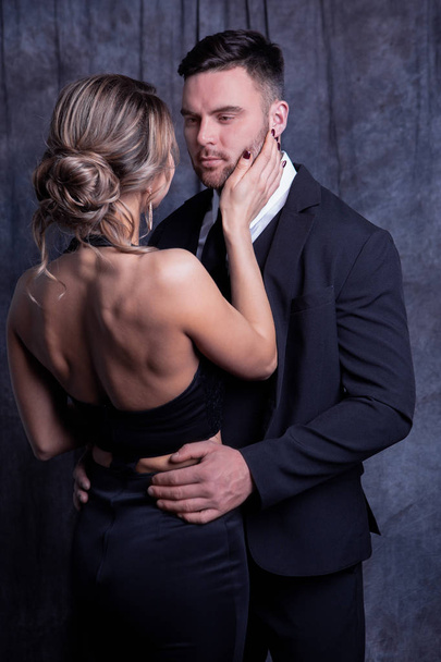 Elegant young man and woman tenderly embrace each other enjoying this moment - Photo, image