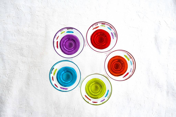 Colorful drinking glasses on white background - Фото, изображение