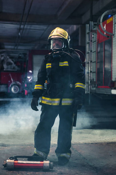 Portrait of a female firefighter wearing a helmet and all safety - Photo, Image