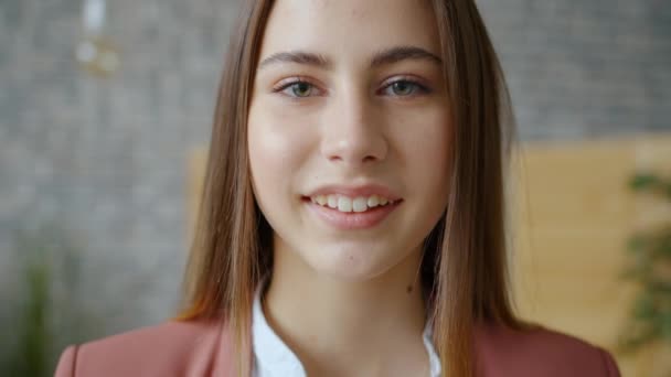 Portrait of good-looking young lady standing in apartment alone smiling - Záběry, video