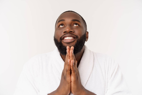 Black guy wearing a bathrobe pointing finger with surprise and happy emotion. Isolated over whtie background. - Fotoğraf, Görsel
