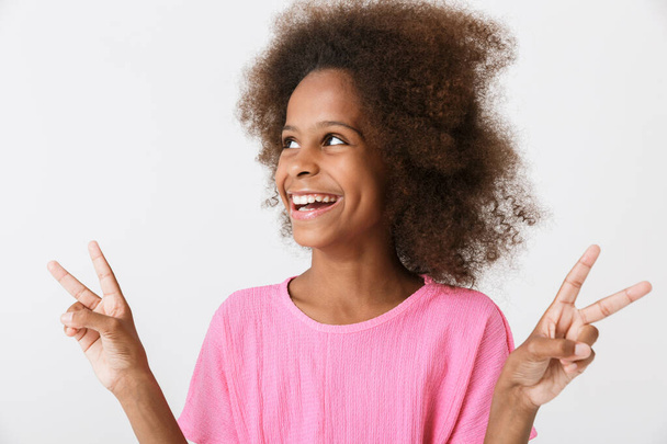 Cheerful little african girl wearing pink blouse standing - Фото, зображення