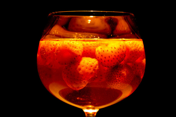 Lighted glass filled with strawberry punch - Photo, Image