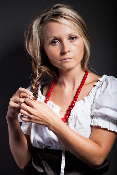 Folk woman in folklore clothes braiding a plait - Foto, imagen