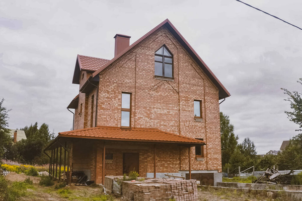 Güzel pembe tuğlalı ev ve turuncu çatı. Doğrulanmış Karşılaşma - Fotoğraf, Görsel