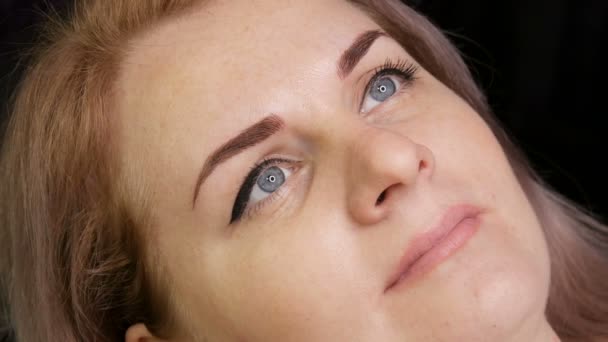 Bellissimo viso di giovane donna con trucco permanente delle sopracciglia e frecce dipinte ad occhio nudo
 - Filmati, video