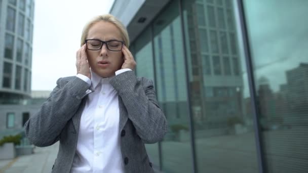 Adult female office worker suffering strong headache, taking medicaments, pain - Imágenes, Vídeo