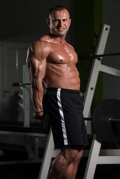 Mature Bodybuilder Flexing Muscles - Photo, image