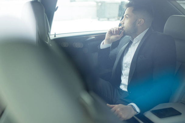 thoughtful man looking side inside of car - Foto, Imagem
