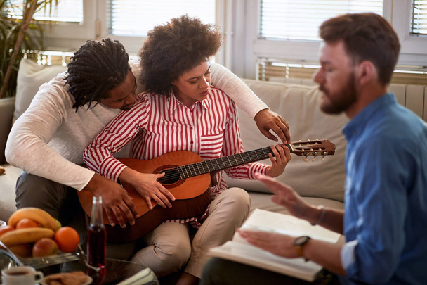 Man teaches woman to play guitar  - Zdjęcie, obraz