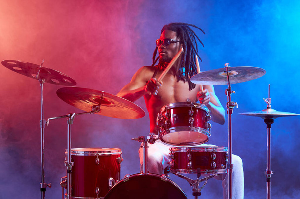 portrait of talented drummer man with black naked skin - Photo, Image