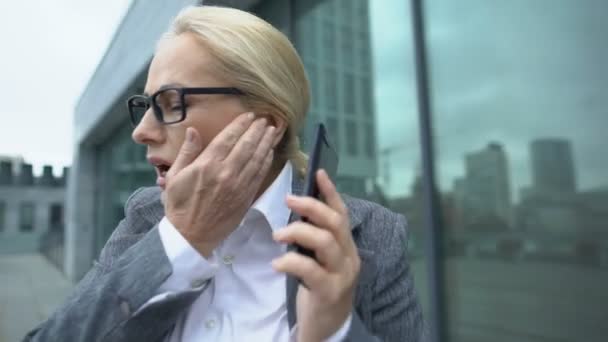 Old lady in business suit suffering strong headache, touching temples, health - Footage, Video