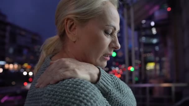 Tired lady massaging numb shoulder, suffering from spine ache, pinched nerve - Séquence, vidéo