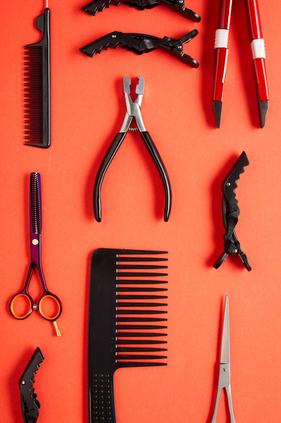 Werkzeuge zum Auftragen von Keratinkapseln auf rotem Hintergrund - Foto, Bild