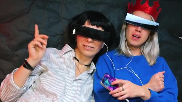 Two same-sex partners listen to music on headphones.  - Video, Çekim