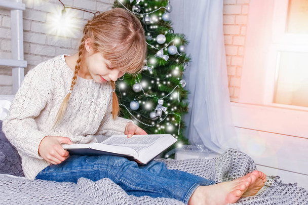 happy child reading a book at christmas - Valokuva, kuva