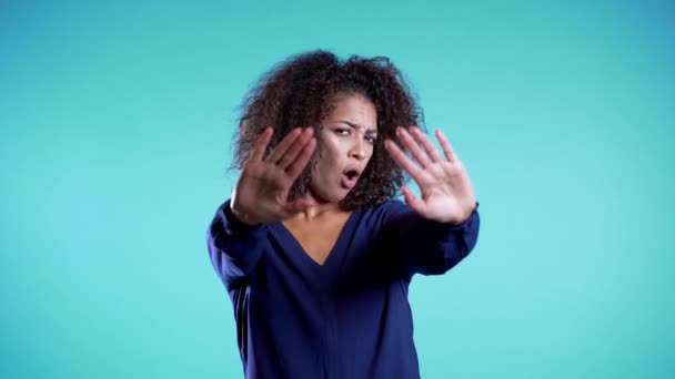 Angry annoyed woman raising hands up to say no stop. Sceptical and distrustful look, feeling mad at someone. Afro girl facial expressions, emotions and feelings. Body language. - Video
