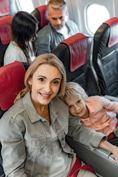 Happy woman is looking at camera in cabin - Photo, image