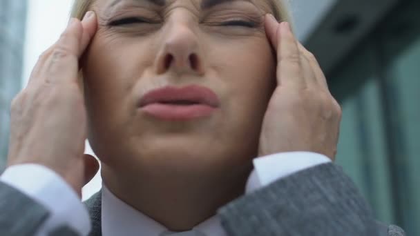 Stressed office worker feeling headache massaging temple, health care, pressure - Video