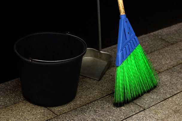Bright blue and green synthetic street mop with black bucket and a scoop - Photo, Image