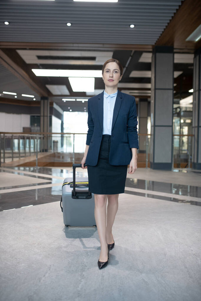 Slim successful businesswoman entering hotel while coming for business trip - Foto, Bild