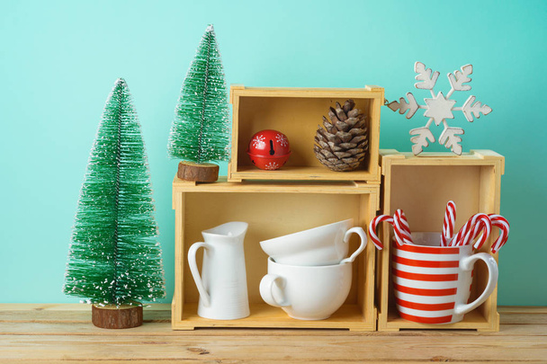 Christmas holiday concept with cups, decorations and pine tree o - Фото, зображення