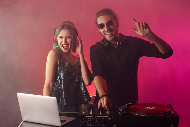 Young djs playing music in nightclub - Photo, image