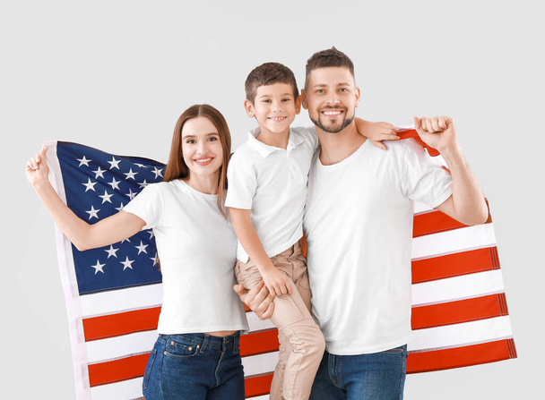 Family with USA flag on light background. Memorial Day celebration - Photo, image