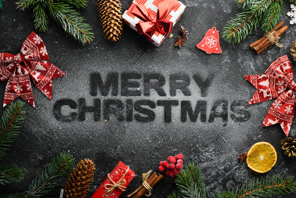 The banner with the words "Merry Christmas". Top view. On a black stone background. - Zdjęcie, obraz