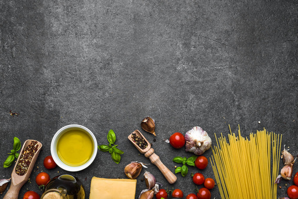 Italian food, ingredients of spaghetti: pasta, parmesan, olive oil, basil - Photo, Image