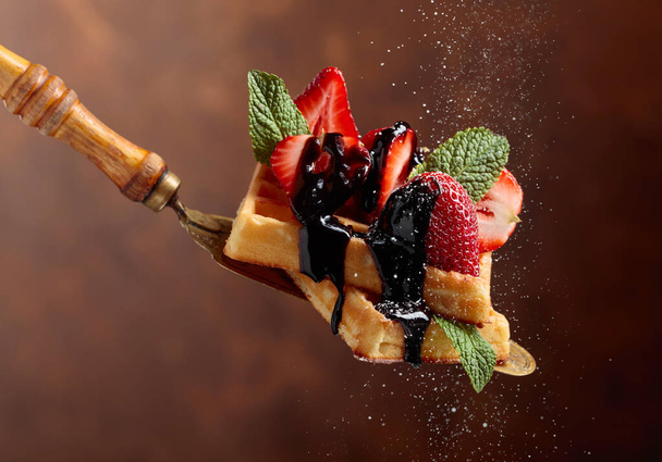 Belgian waffles with strawberries, mint and chocolate sauce. - Photo, Image