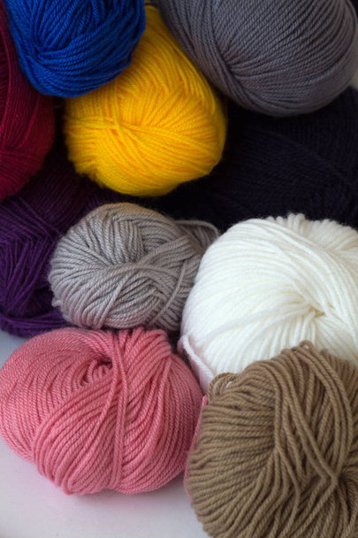 colorful wool balls of yarn on white background - Фото, изображение