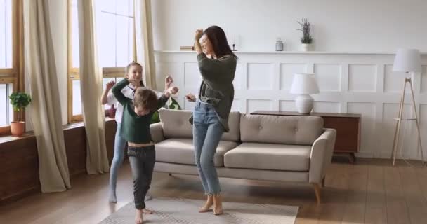 Happy single mother and funny kids jump dance at home - Video, Çekim