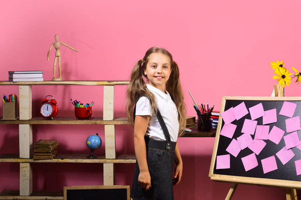 Schoolgirl with proud face in her classroom - Fotó, kép