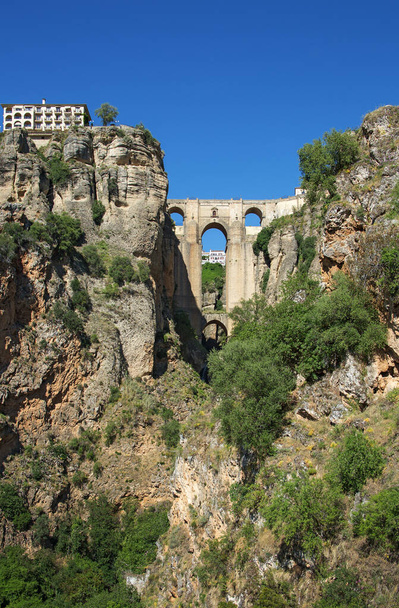 Ponte Nuevo (the New Bridge) in Ronda, Spain. This bridge spans the 120-metre-deep (390 ft) chasm that carries the Guadalev�n River and divides the city of Ronda - Photo, Image