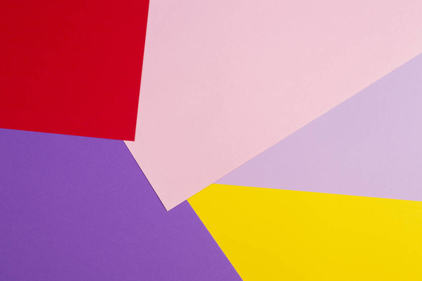 Color papers geometry flat composition background with violet, purple, pink, red, yellow tones. - Foto, imagen