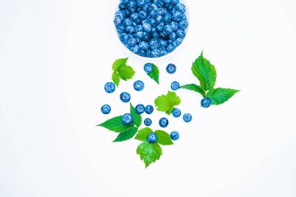 Fresh blueberries on a white background. Healthy summer fruit. Taste of summer. Growing of blueberries. Advertising on blueberries. Fresh blueberries on a white.  - Photo, Image