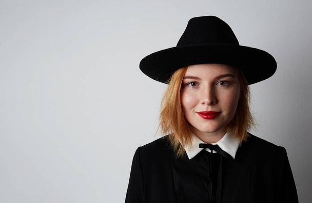 Portrait of hipster girl wearing black dress and hat. Isolated and space for text. - Фото, зображення
